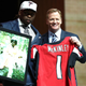 Takkarist McKinley of UCLA poses with NFL CommissionerRoger Goodell and a photo of his grandmother, Myrtle Collins, after being picked 26th overall by the Atlanta Falcons during the first round of the 2017 NFL draft April 27, 2017, in Philadelphia. (Elsa/Getty Images)